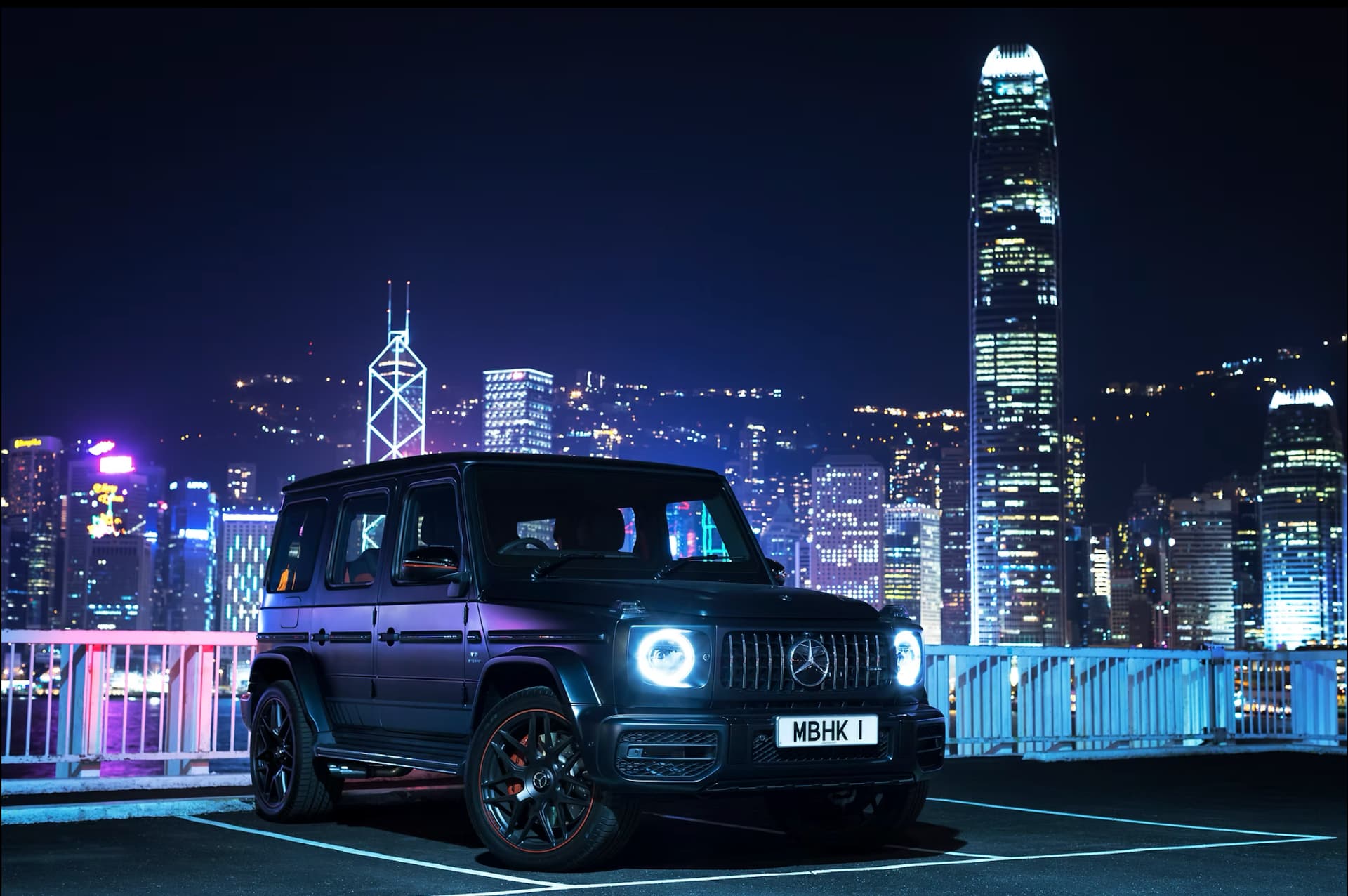 Mercedes-Benz G-Class against an illuminated city skyline at night